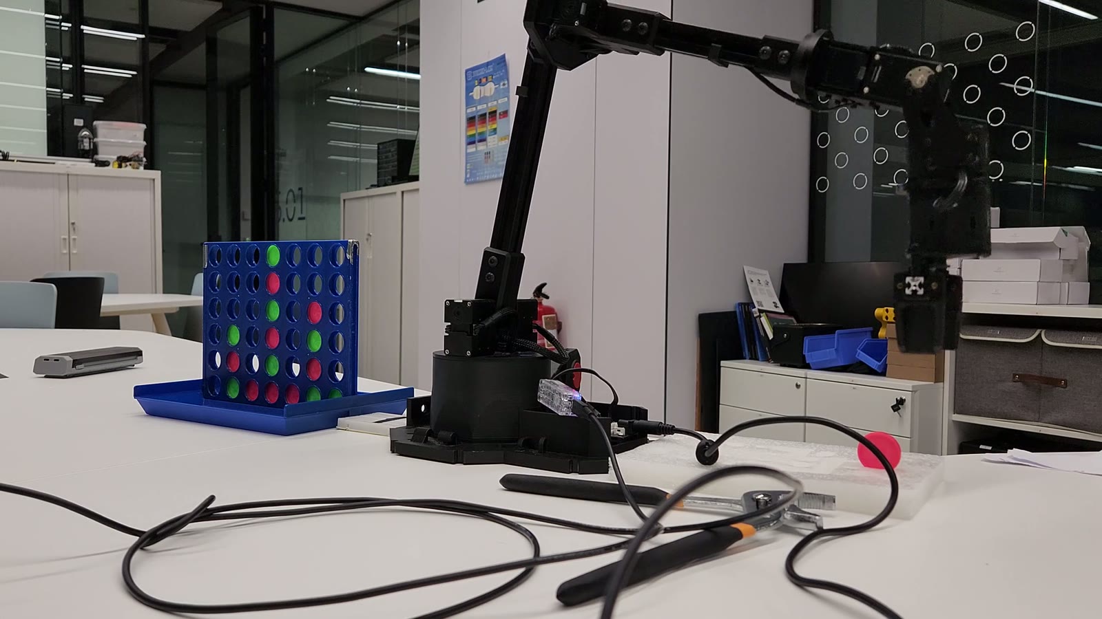VictorIA robotic arm positioned beside its Connect Four board